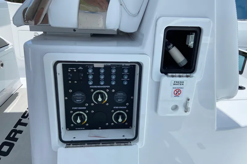 Slide: The Image of Control panel and fresh water compartment on 2026 Sportsman Heritage 321 Center Console boat. - 25