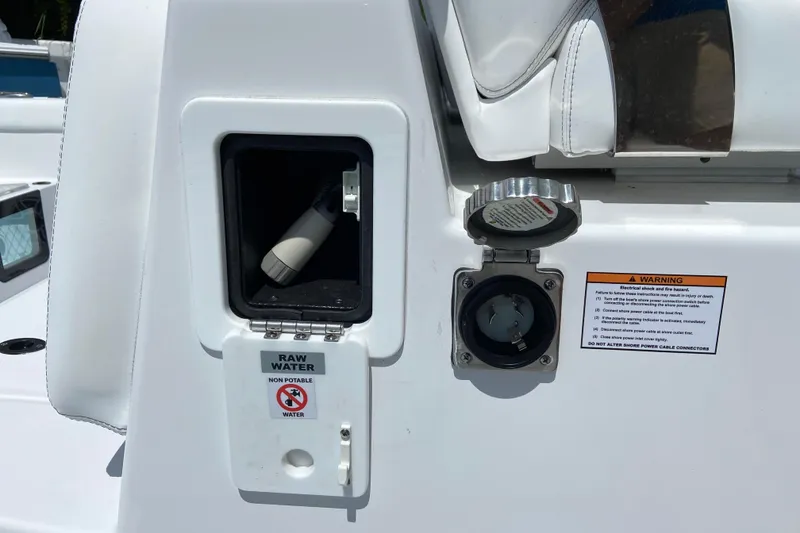 Slide: The Image of 2026 Sportsman Heritage 321 Center Console boat with raw water access and warning label. - 27