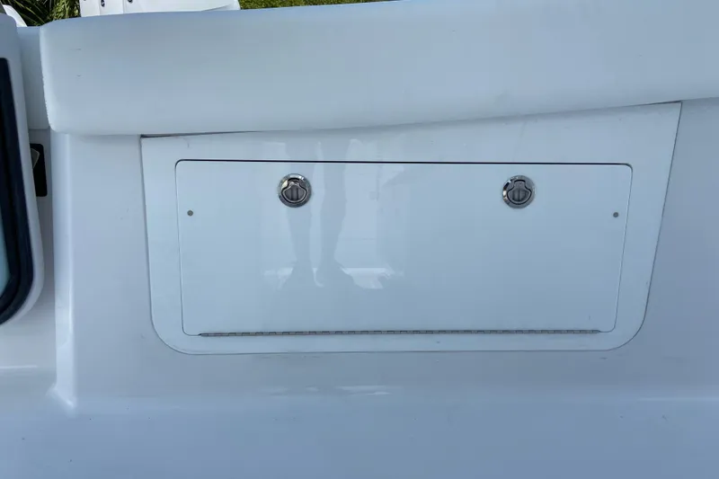 Slide: The Image of 2026 Sportsman Heritage 321 Center Console storage compartment with dual latches. - 28