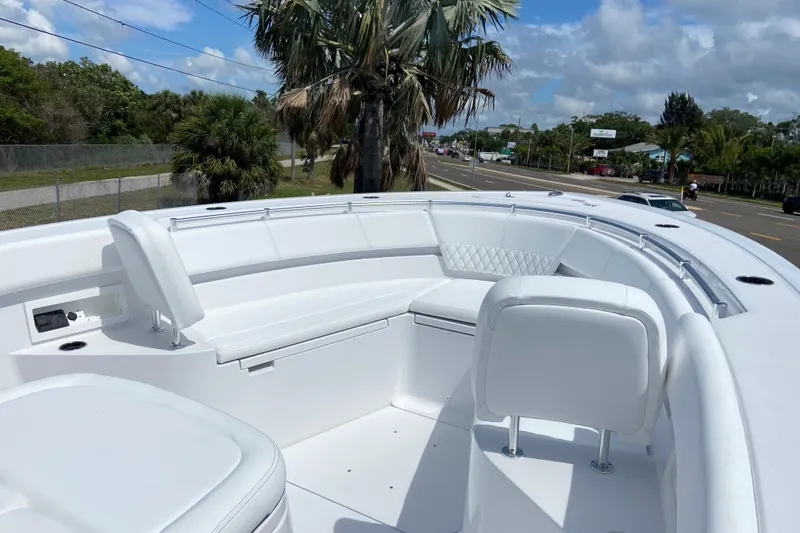 Slide: The Image of 2026 Sportsman Heritage 321 Center Console boat with sleek white seating and modern design. - 40