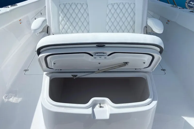 Slide: The Image of 2026 Sportsman Heritage 321 Center Console boat seat with open storage compartment. - 44