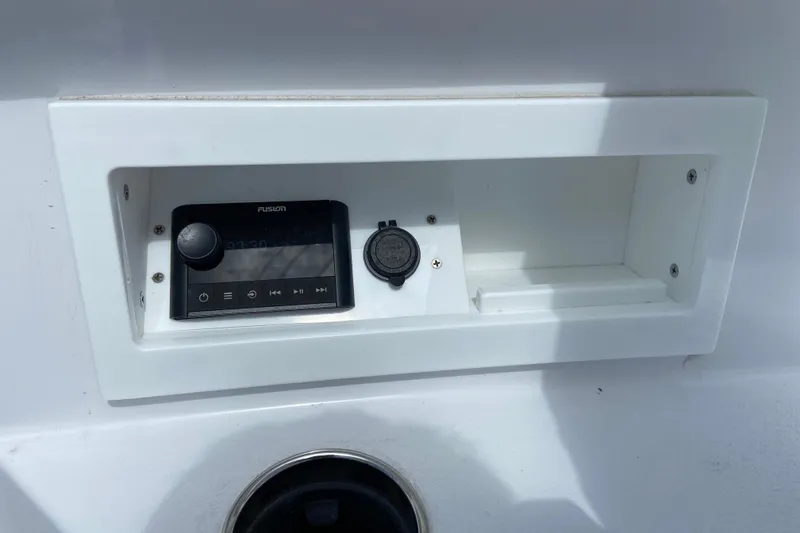 Slide: The Image of Control panel on 2026 Sportsman Heritage 321 Center Console boat, featuring Fusion audio system. - 47