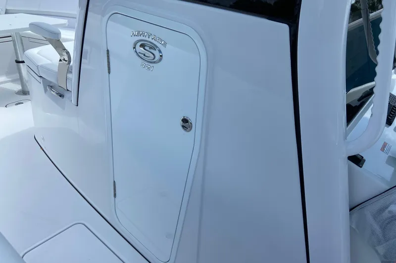 Slide: The Image of 2026 Sportsman Heritage 321 Center Console boat interior, featuring sleek white design and seating. - 48