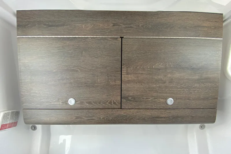Slide: The Image of Wooden cabinet doors on 2026 Sportsman Heritage 321 Center Console boat interior. - 51