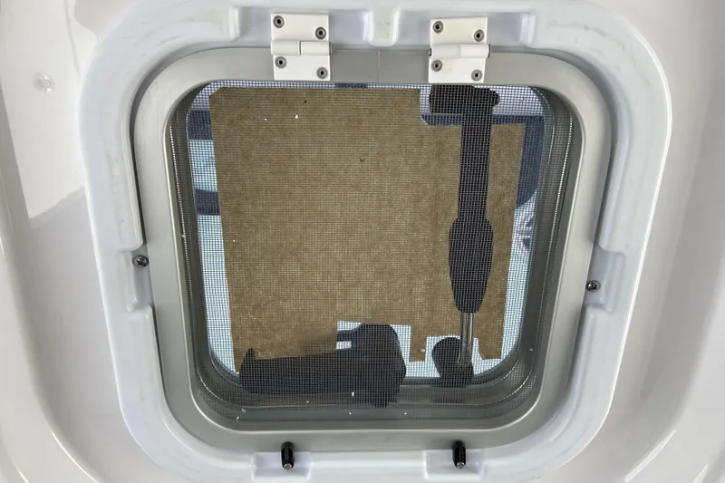Slide: The Image of Hatch window of 2026 Sportsman Heritage 321 Center Console boat, featuring screen and latch. - 53