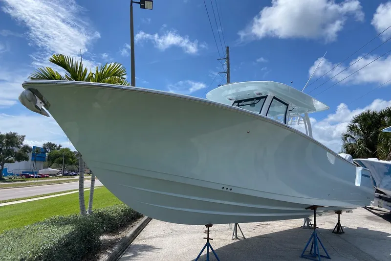 The Image of 2026 Sportsman Heritage 321 Center Console boat displayed outdoors under a clear blue sky. - 0