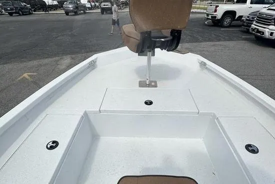 Slide: The Image of 2025 Xpress H20B Bay boat deck with seating, parked in a lot. - 11