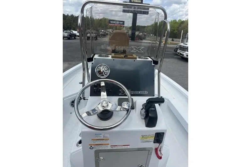 Slide: The Image of 2025 Xpress H20B Bay boat console with steering wheel and controls. - 13