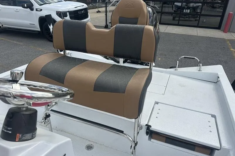 Slide: The Image of 2025 Xpress H20B Bay boat interior with tan and gray seating. - 3