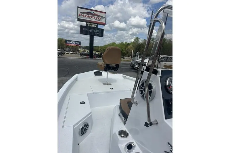 Slide: The Image of 2025 Xpress H20B Bay boat interior with seating and dashboard, outdoors under cloudy sky. - 4