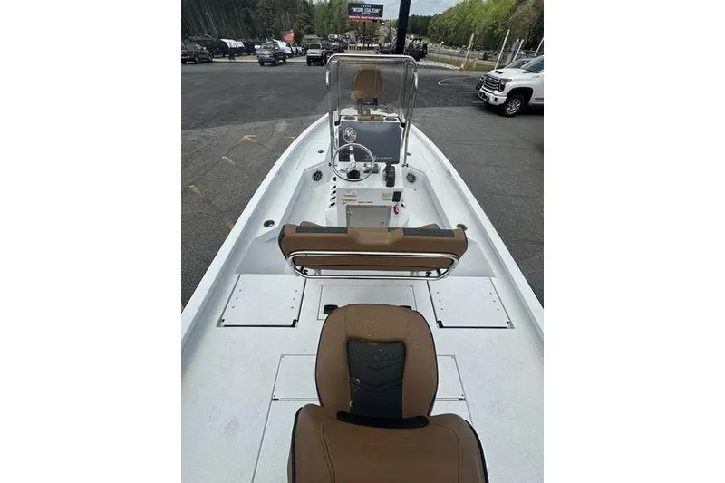 Slide: The Image of 2025 Xpress H20B Bay boat interior with tan seating and steering console. - 7