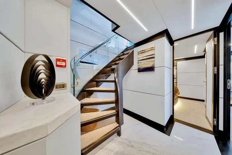 Slide: The Image of Luxurious interior of 2020 Hargrave C92 yacht with modern staircase and elegant decor. - 100