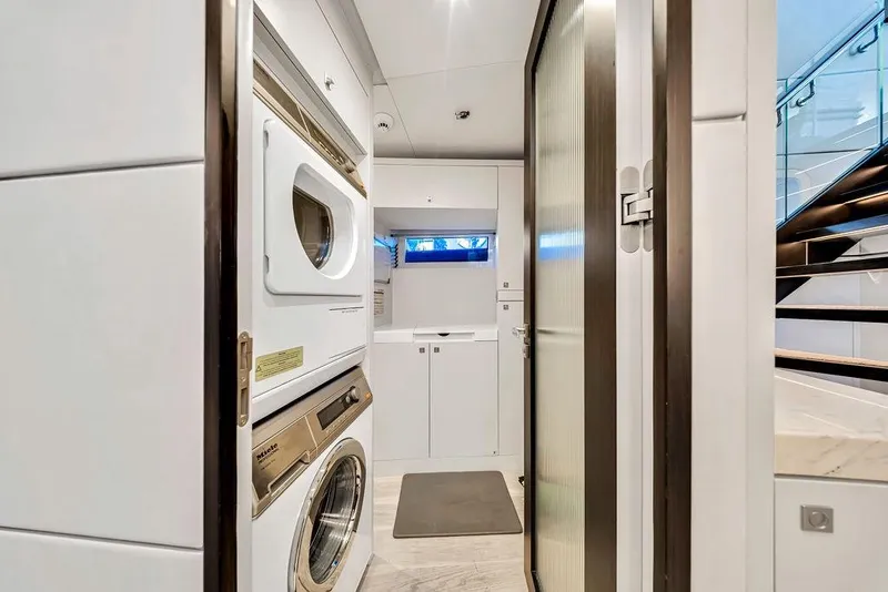 Slide: The Image of Laundry area inside 2020 Hargrave C92 yacht with modern appliances and sleek design. - 104