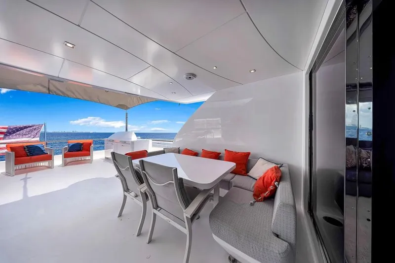 Slide: The Image of Luxurious 2020 Hargrave C92 yacht deck with seating, ocean view, and American flag. - 31
