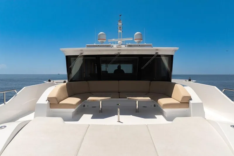 Slide: The Image of Luxurious 2020 Hargrave C92 yacht deck with seating, ocean view, and clear blue sky. - 38