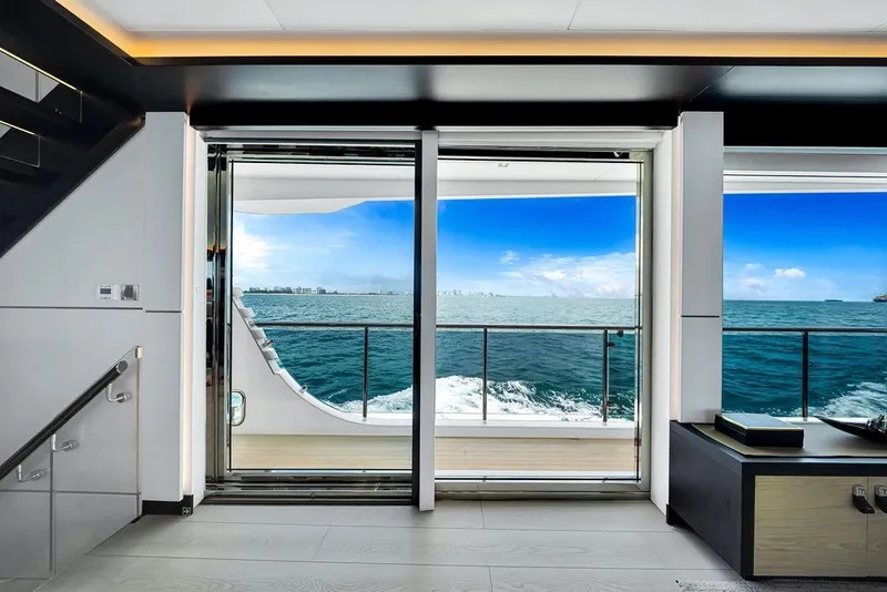 Slide: The Image of Luxurious interior view from 2020 Hargrave C92 yacht, overlooking ocean and skyline. - 59
