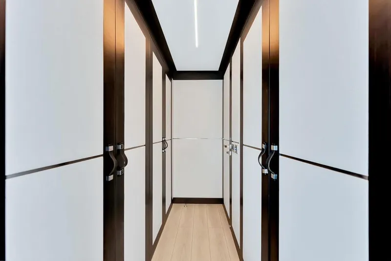 Slide: The Image of Luxurious walk-in closet on 2020 Hargrave C92 yacht, featuring sleek cabinetry and modern design. - 90