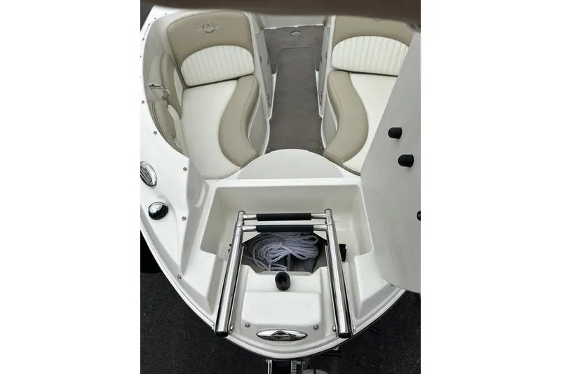 Slide: The Image of 2015 Stingray 208 LR boat interior with seating and storage compartment. - 10