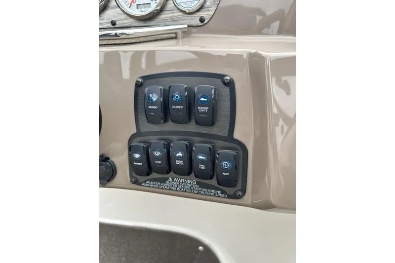 Slide: The Image of Control panel of a 2015 Stingray 208 LR boat with various switches. - 13