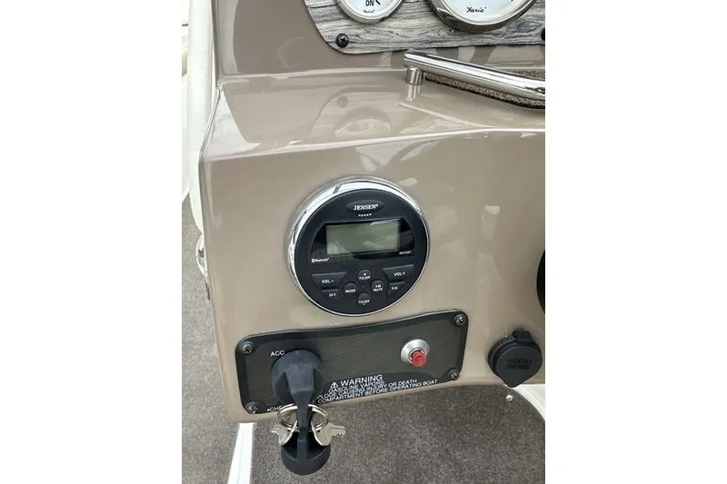 Slide: The Image of Dashboard of a 2015 Stingray 208 LR boat with Jensen stereo system. - 16