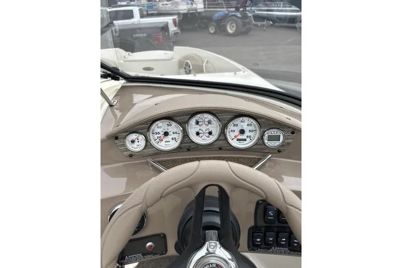 Slide: The Image of Dashboard view of a 2015 Stingray 208 LR boat with gauges and steering wheel. - 17