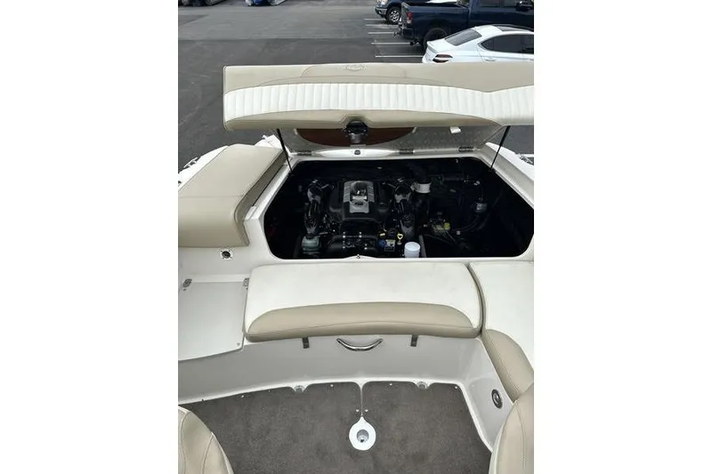 Slide: The Image of 2015 Stingray 208 LR boat engine compartment with open hatch, showcasing interior mechanics. - 19