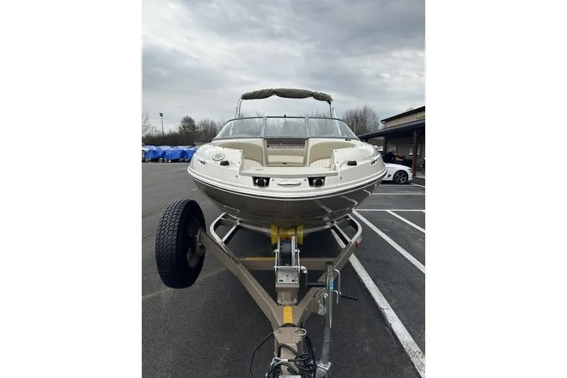 Slide: The Image of 2015 Stingray 208 LR boat on trailer in parking lot. - 6