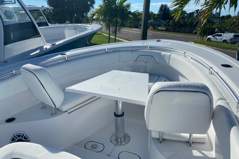 Slide: The Image of 2026 Sportsman Open 282 Center Console boat with seating and table in the bow area. - 16