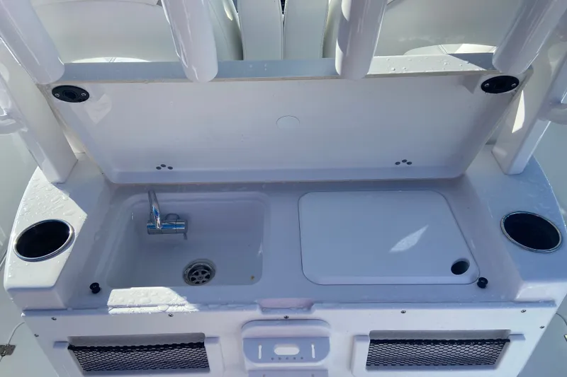Slide: The Image of 2026 Sportsman Open 282 Center Console boat sink and storage area. - 8