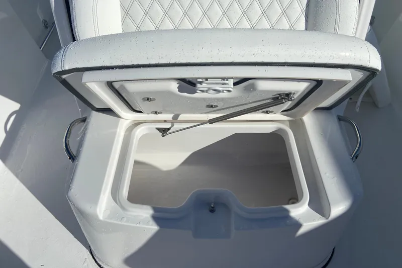 Slide: The Image of Open storage compartment on 2026 Sportsman Open 282 Center Console boat, featuring cushioned seating. - 20