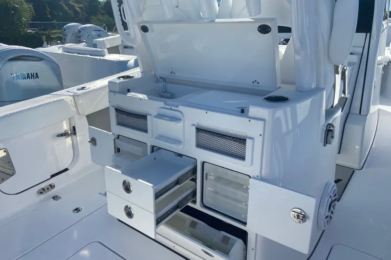 Slide: The Image of 2026 Sportsman Open 282 Center Console boat with storage compartments and Yamaha engines. - 7