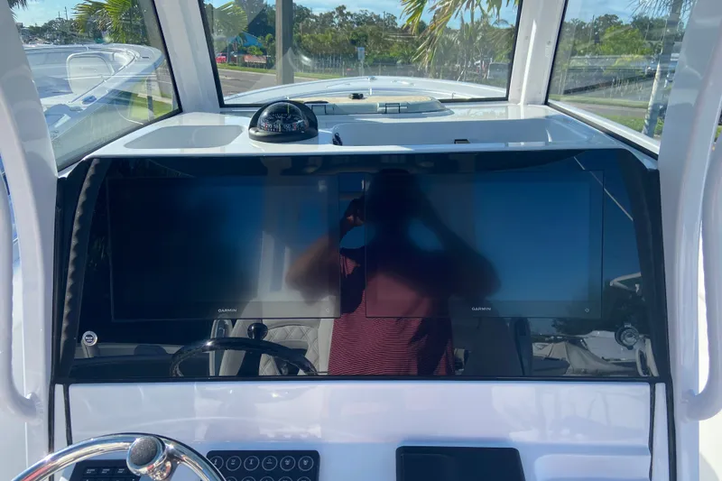 Slide: The Image of 2026 Sportsman Open 282 Center Console dashboard with dual Garmin displays and compass. - 14