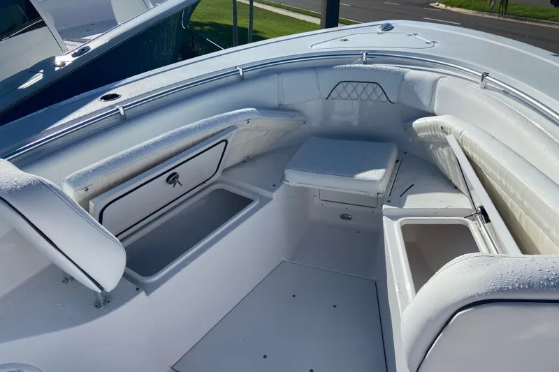Slide: The Image of 2026 Sportsman Open 282 Center Console boat interior with seating and storage compartments. - 18