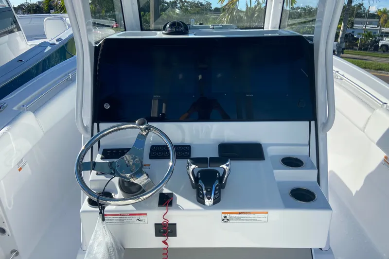 Slide: The Image of 2026 Sportsman Open 282 Center Console helm with steering wheel and controls. - 11