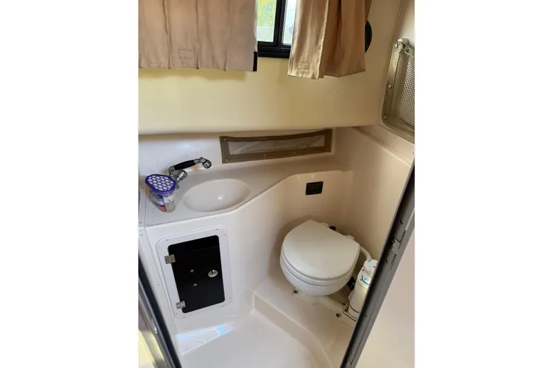 Slide: The Image of 2005 Grady-White Sailfish 282 boat bathroom with sink, toilet, and storage cabinet. - 13