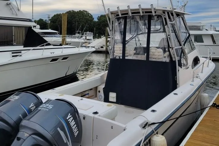 Slide: The Image of 2005 Grady-White Sailfish 282 boat docked, featuring twin Yamaha 225 engines. - 2