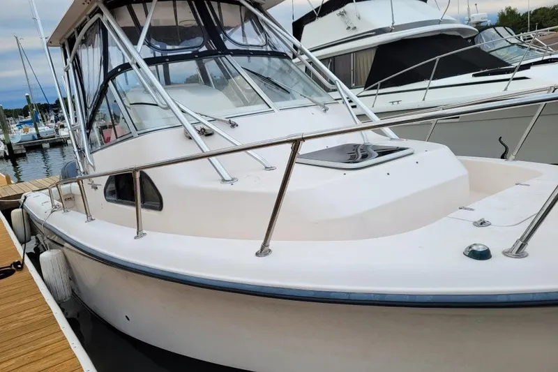 Slide: The Image of 2005 Grady-White Sailfish 282 boat docked at marina, showcasing sleek design and sturdy build. - 4