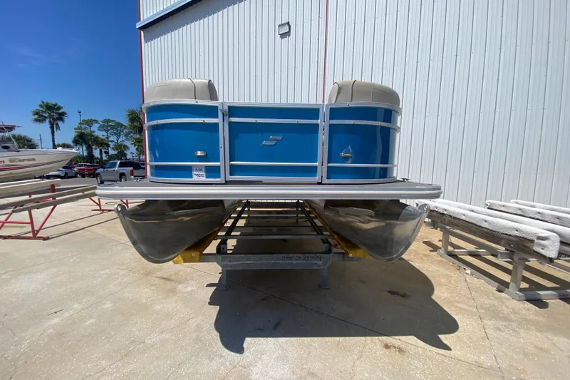 Slide: The Image of 2020 Star Craft 20 DLX pontoon boat in a marina setting, sunny day. - 3