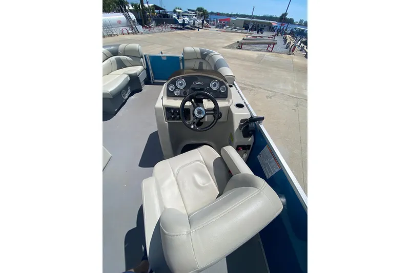 Slide: The Image of 2020 Star Craft 20 DLX boat interior with steering console and seating. - 6