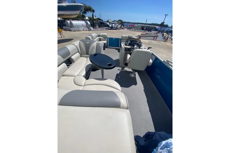Slide: The Image of 2020 Star Craft 20 DLX pontoon boat interior with seating and steering console. - 7