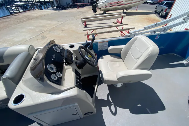 Slide: The Image of 2020 Star Craft 20 DLX boat cockpit with steering wheel and captain's chair. - 8