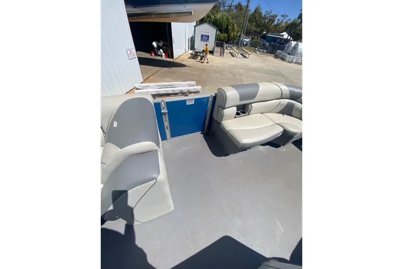 Slide: The Image of Interior view of 2020 Star Craft 20 DLX boat with gray seating and open deck. - 9