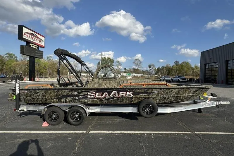 The Image of 2026 SeaArk EasyCat boat on trailer in parking lot under blue sky. - 0