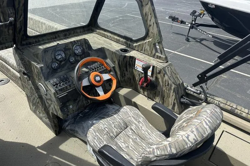 Slide: The Image of 2026 SeaArk EasyCat boat interior with camouflage design and orange steering wheel. - 10