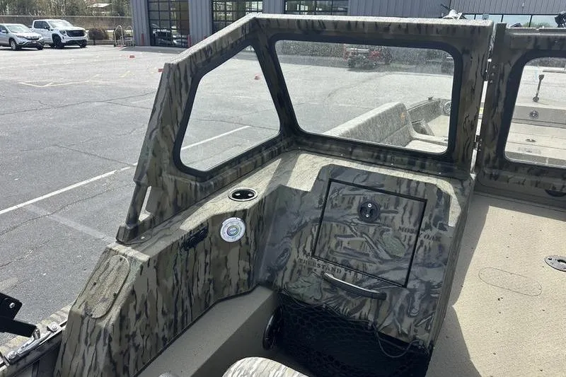 Slide: The Image of 2026 SeaArk EasyCat boat interior with camouflage design and windshield in a parking lot. - 13