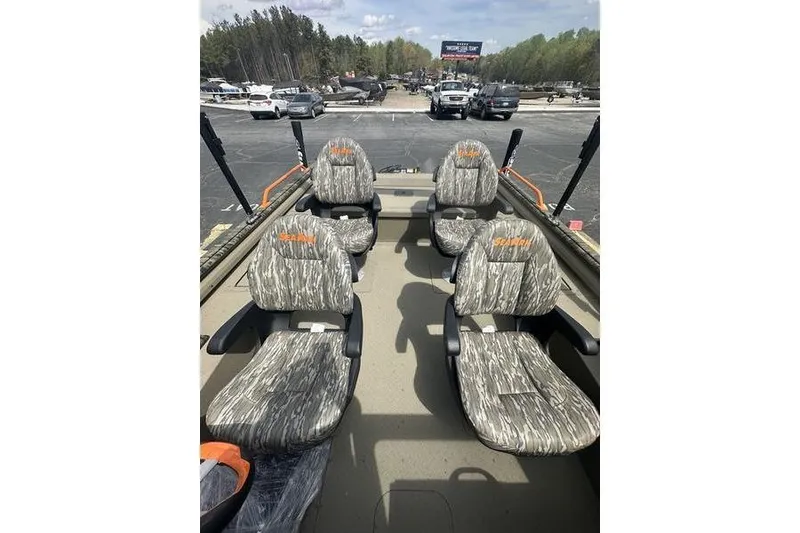 Slide: The Image of 2026 SeaArk EasyCat boat interior with camo-patterned seats in a parking lot. - 18
