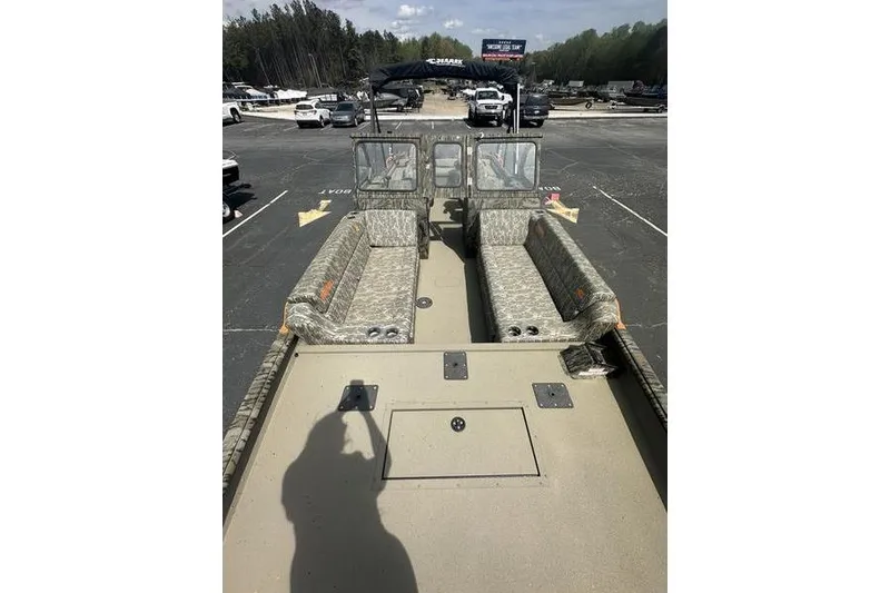 Slide: The Image of 2026 SeaArk EasyCat boat with camouflage seating, parked in a lot under clear skies. - 19