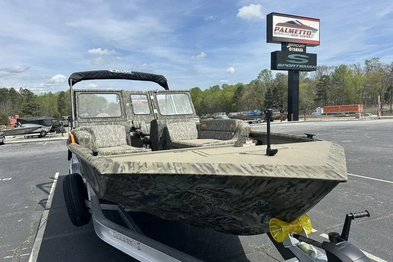Slide: The Image of 2026 SeaArk EasyCat boat on trailer at Palmetto Boat Center, under clear sky. - 2