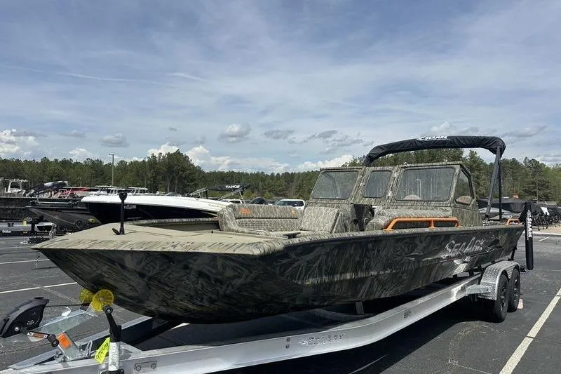 Slide: The Image of 2026 SeaArk EasyCat boat on trailer, parked outdoors under a clear sky. - 5