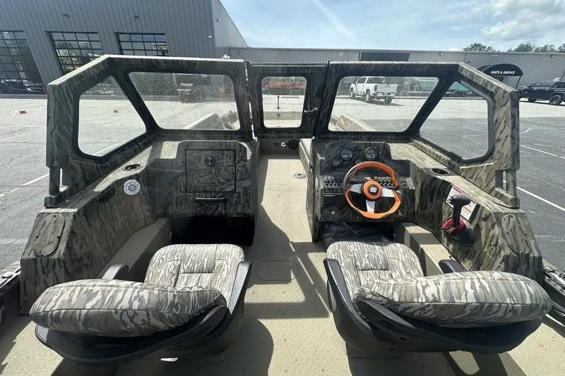 Slide: The Image of Interior of a 2026 SeaArk EasyCat boat with camouflage seating and steering wheel. - 6
